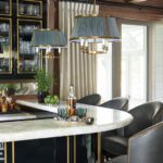 A glamorous home bar with slate blue lighting and bar stools