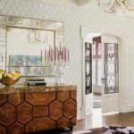 Cotemporary foyer with patterned wall paper and French buffet.