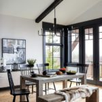 Dining area with a contemporary wooden table and Windsor chairs.