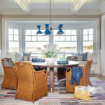 Coastal dining room with a round table and rattan chairs