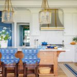 Coastal white kitchen with blue and white chairs