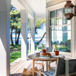 Cape Cod porch with small round dining table.