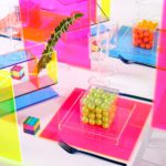 Colorful table display with lucite boxes and candy