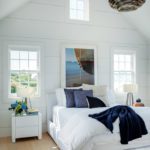 White guestroom with a pithed ceiling