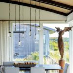 Contemporary dining area with hanging pendants an sculpture