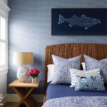 Blue coastal bedroom with a banana leaf headboard