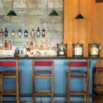 Lake house bar with a wall covered in stone