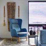 Blue chair in the corner of a family room.