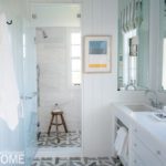 All white coastal bathroom with large walk in shower.