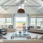 Nantucket living room with metal shark sculpture hanging from the ceiling