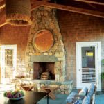 Outdoor seating area with large stone fireplace