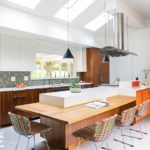 Contemporary kitchen with a large wood and Caesarstone countertop.