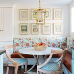 Banquette upholstered in a cheerful floral design and a round table.