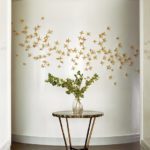White entryway with gold ceramic flower installation