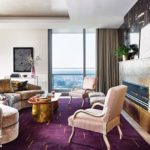 Living room with purple rug and gold table.