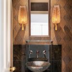 Bathroom with textured wall covering and Murano glass sconces.