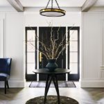 contemporary entry with white walls and a black round table.