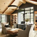 Home office with a seating area, wood ceiling, and gray walls.