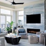 Coastal great room with neutral furnishings and blue marble fireplace