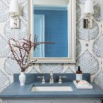 Powder room with blue and white patterned wallpaper.