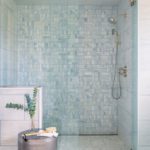 Large walk in shower with blue tile.