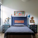 Primary bedroom with blue painted bed.
