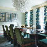 Dining room with tall upholstered velvet chairs and patterned curtains