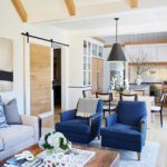 Casual family room with blue chairs and a barn door.