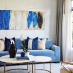 Living room with a blue couch and contemporary art