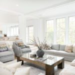 Living room with large window and neutral furnishings by Blueprint Advisors