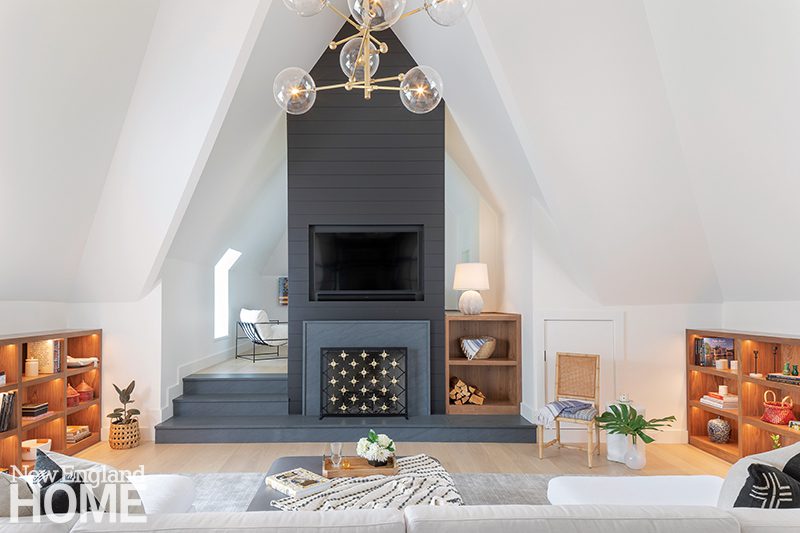 Attic space with black stone fireplace. 