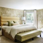 Primary bedroom with an upholstered bed and elegant wallpaper.
