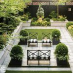 Formal Boston garden with large urns and wrought iron furniture