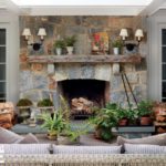 Large stone fireplace with decorative sconces.