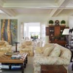 Family room with white upholstered furniture and antiques.