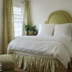 Guest bedroom with a shapely upholstered headboard.