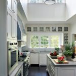 Large white kitchen with a double-height ceiling.