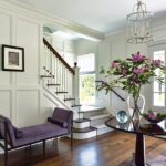 Entryway with a purple upholstered bench.