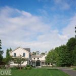 Exterior of New Canaan Home with a rolling green lawn
