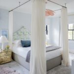 Feminine bedroom with four poster bed.