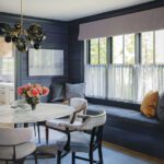Dining nook with dark gray walls and window seat