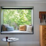 Window seat in a large picture window with a gray cushion