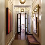 Entry of a home at Boston high-rise with large globe light fixtures and French-style doors
