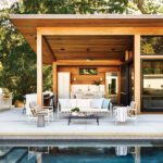Contemporary pool house and rectangular pool