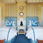 Coastal guest bedroom with yellow and blue accents.