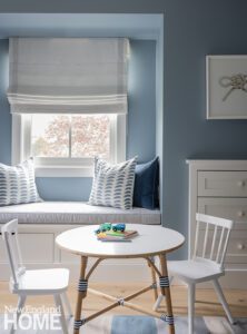Children's room with small round table and a window seat.