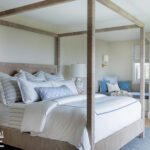 Neutral bedroom with large four poster oak bed.