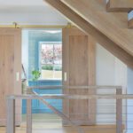 Floating oak staircase in a coastal home.