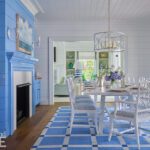 Dining room with a white table and chairs and bright blue walls
