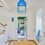 Foyer with white walls and bright blue lanterns